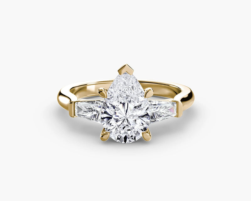 Rose gold ring with a pear-shaped diamond on a white background
