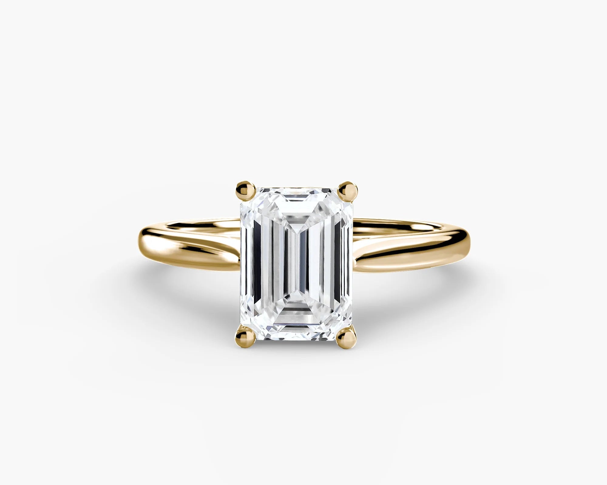 Gold ring with a Emerald diamond on a yellow gold ring solitaire 