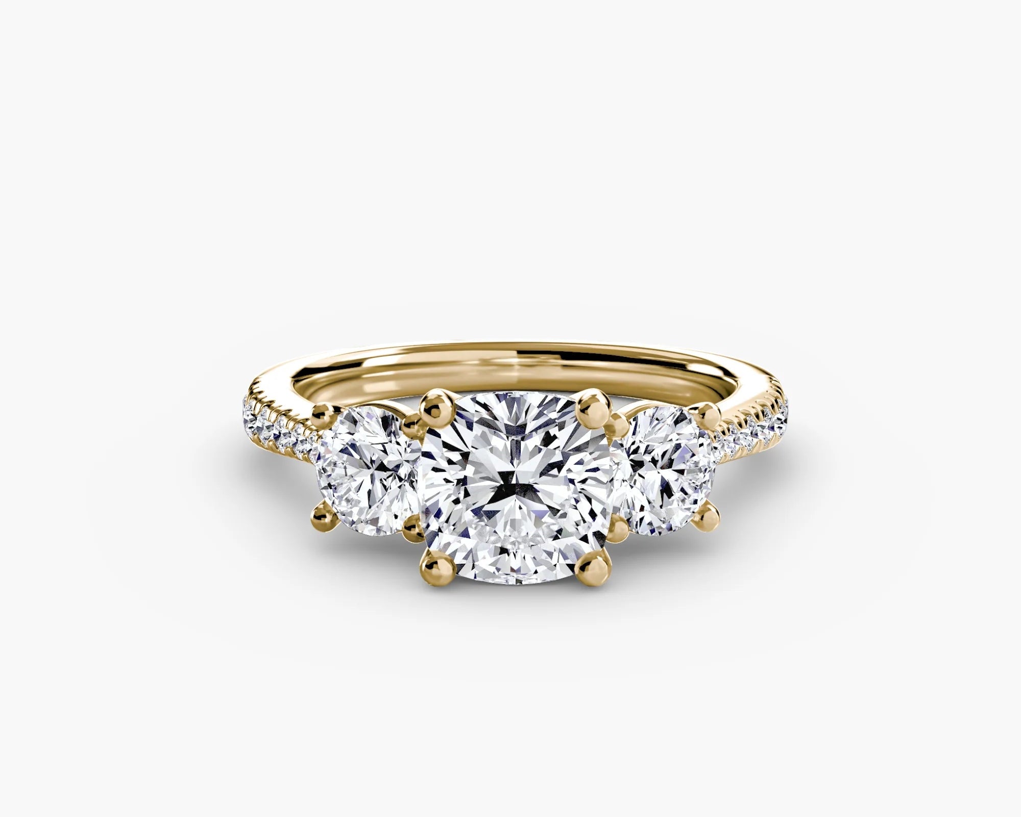Gold ring with three diamonds on a white background