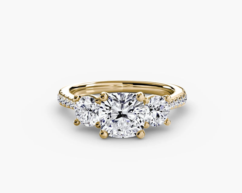 Gold ring with three diamonds on a white background