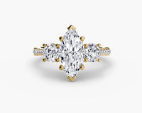 Gold ring with a pear-shaped diamond on a white background