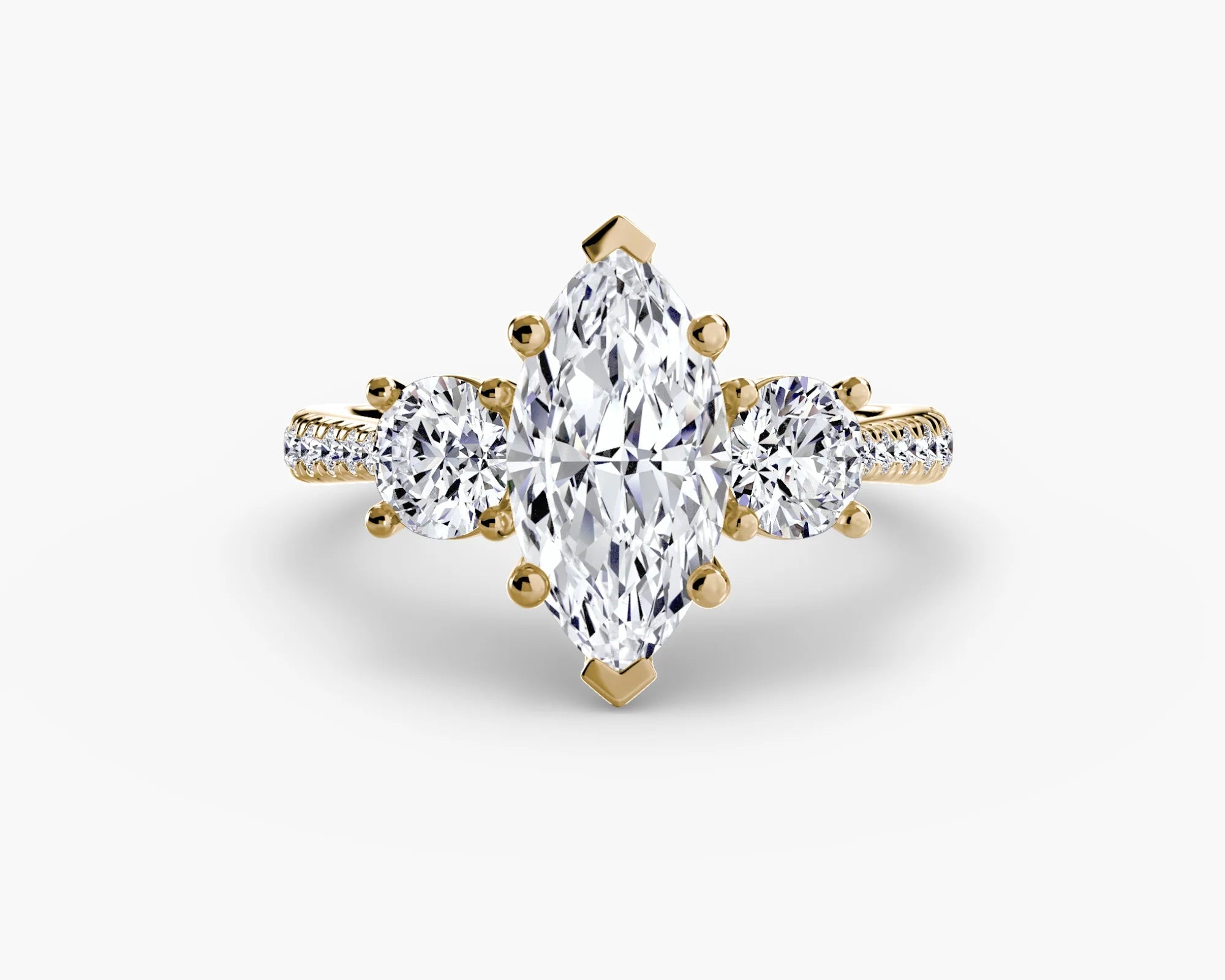 Gold ring with a pear-shaped diamond on a white background