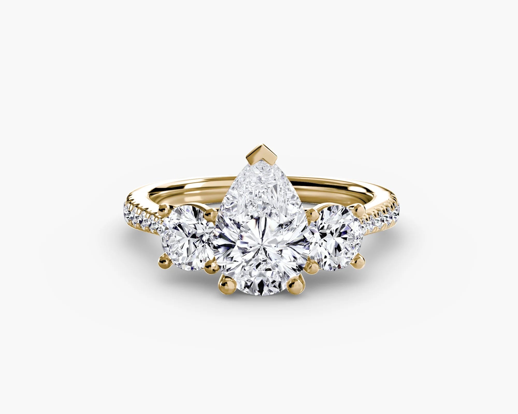 yellow gold ring with three diamond stones on a white background