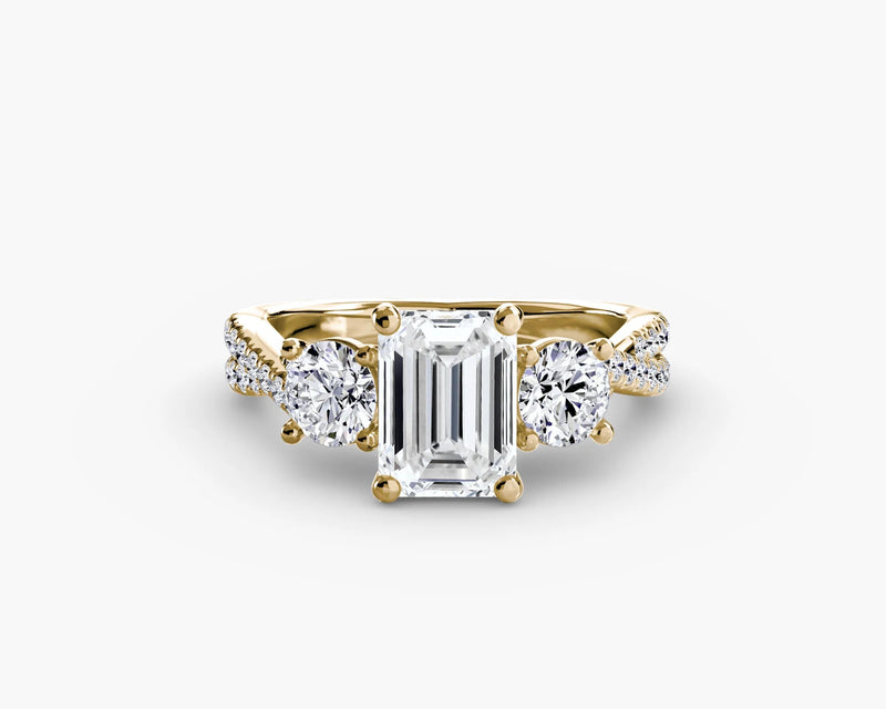 Rose gold ring with emerald-cut diamond and smaller round diamonds on a white background
