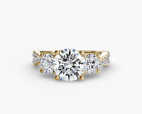 Gold ring with a large central diamond and smaller side diamonds on a white background