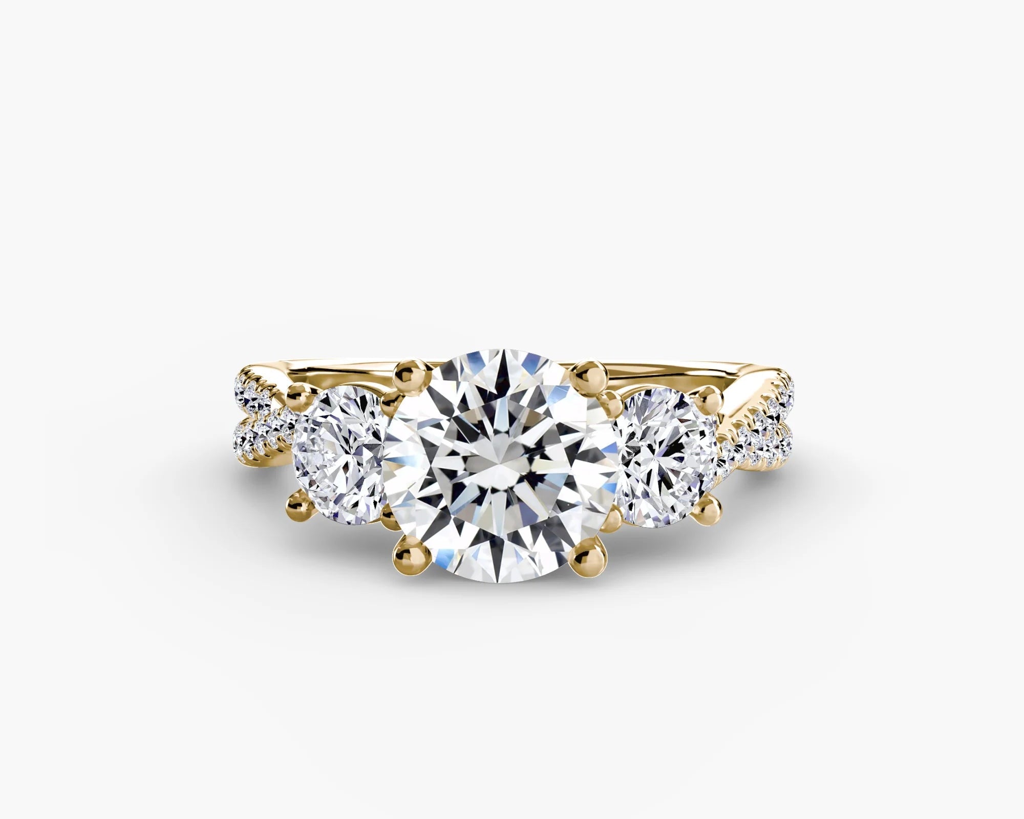 Gold ring with a large central diamond and smaller side diamonds on a white background