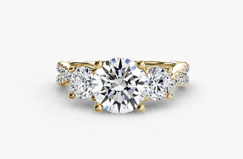 Gold ring with a large diamond and smaller diamonds on the sides against a white background