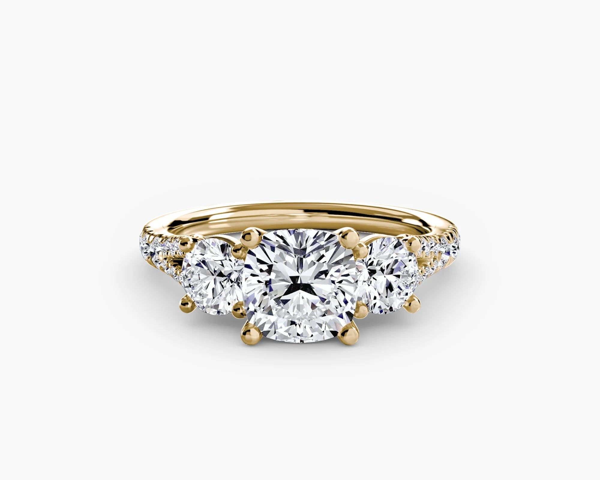 Gold ring with three diamonds on a white background