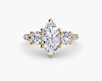 Gold ring with a large central diamond and smaller diamonds on a white background