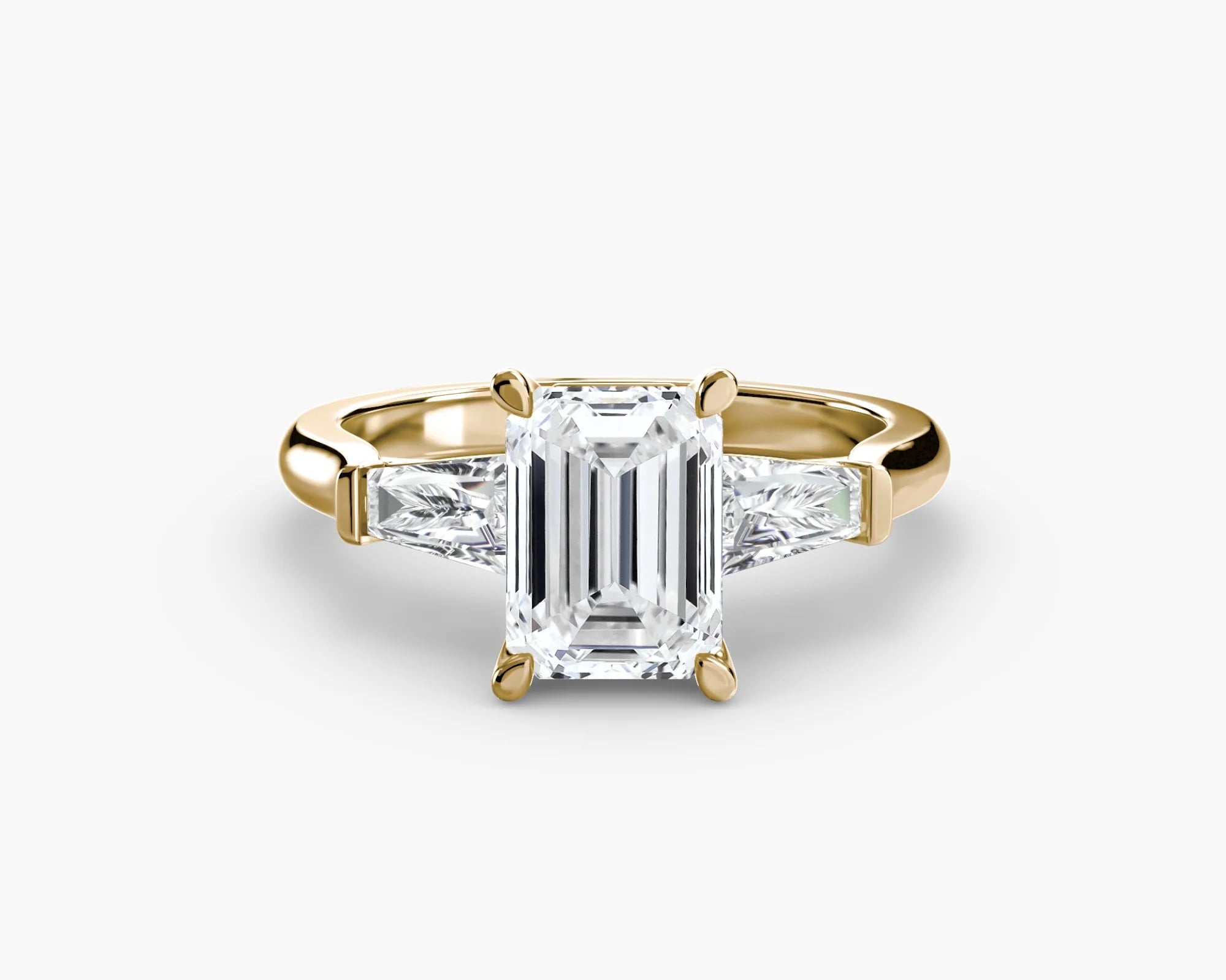 Gold ring with a large diamond and smaller diamonds on the sides against a white background