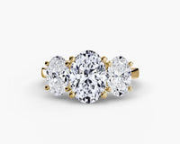 Three-stone diamond ring with gold setting on a white background